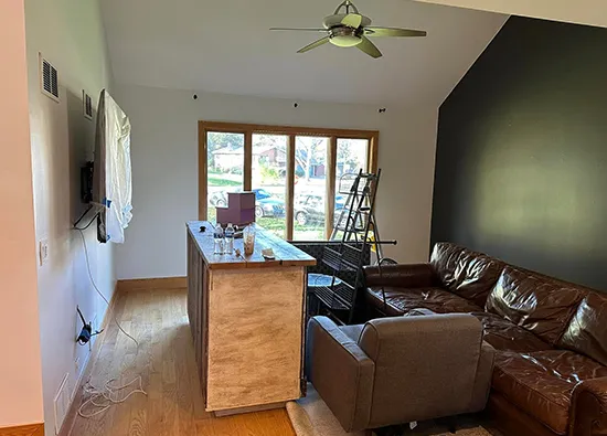 Modern living room with painted wall and windows.